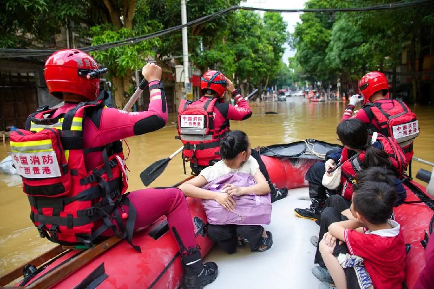 Rescue workers evacuate flood-affected residents by boat after heavy rainfall brought by Typhoon Narra caused flooding in Longzhou county, Chongzuo, Guangxi Zhuang Autonomous Region, China August 24, 2026. (cnsphoto via Reuters) 