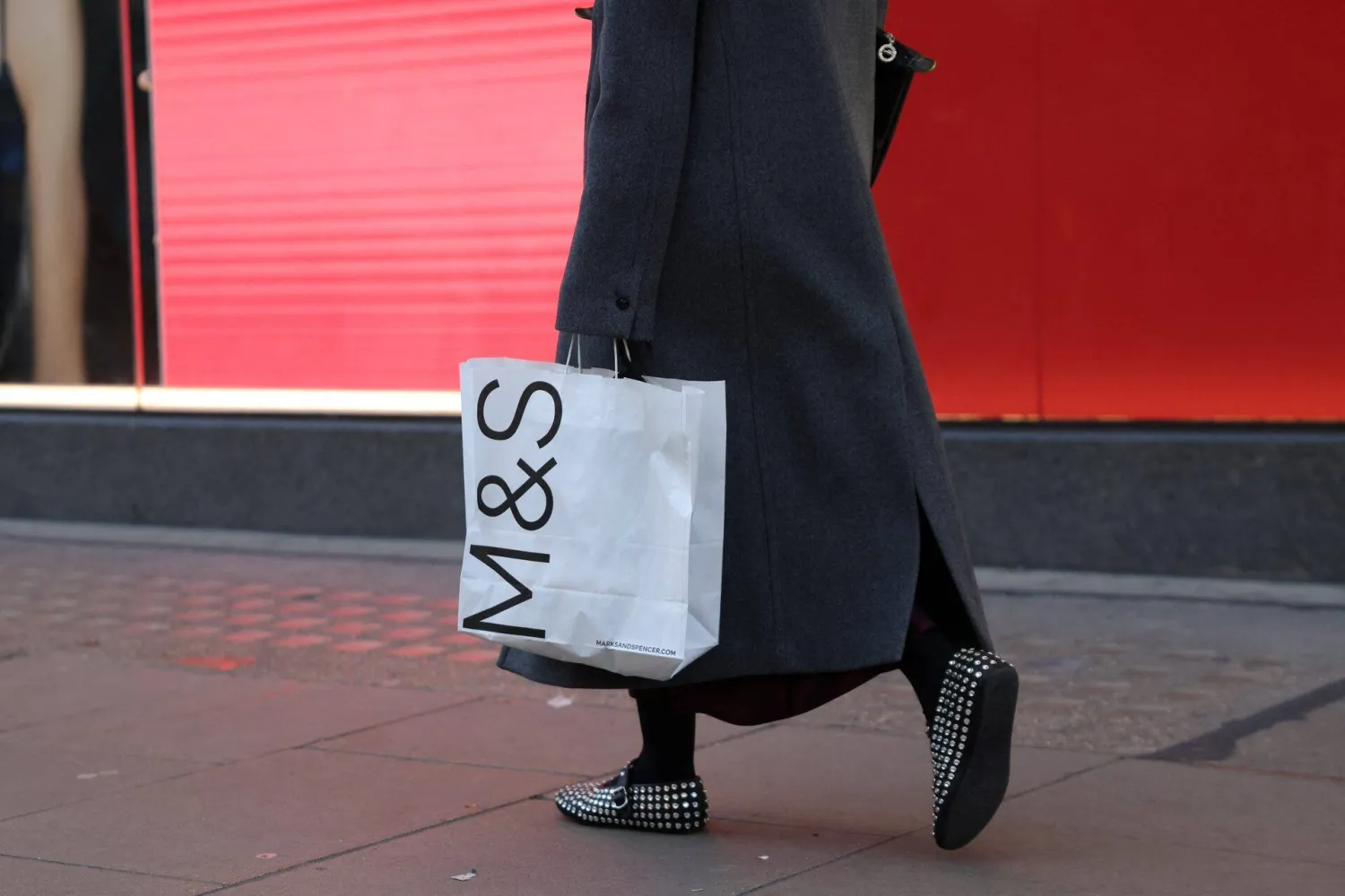 A shopper carries a Marks & Spencer shopping bag in London, Britain, January 2, 2025. (Reuters)