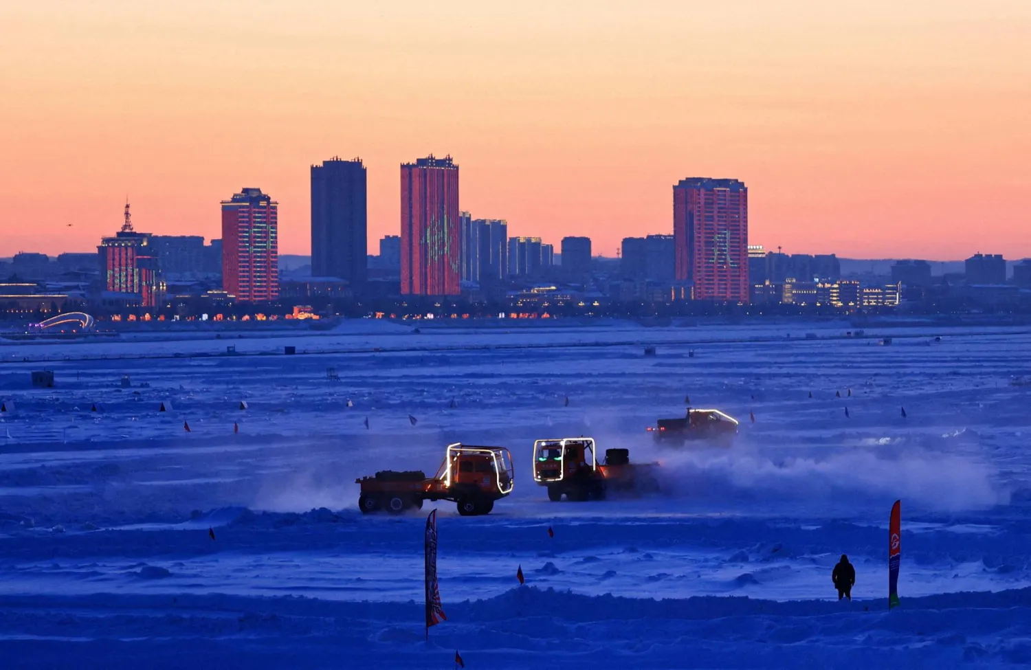 Trucks race on the frozen Amur River during the Russia-China winter sports festival ZimFestAmur, with the Chinese city of Heihe seen in the background, in the far eastern town of Blagoveshchensk, in Amur region, Russia, February 28, 2026. (Reuters) 