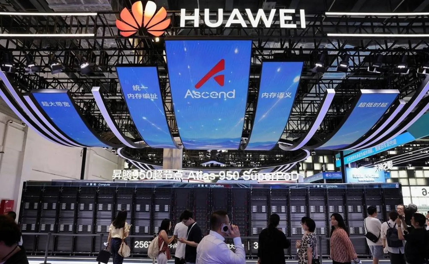People walk past the Huawei booth, where the Atlas 950 SuperPoD system is displayed, during the World Artificial Intelligence Conference (WAIC) in Shanghai, China, July 17, 2026. (Reuters) 