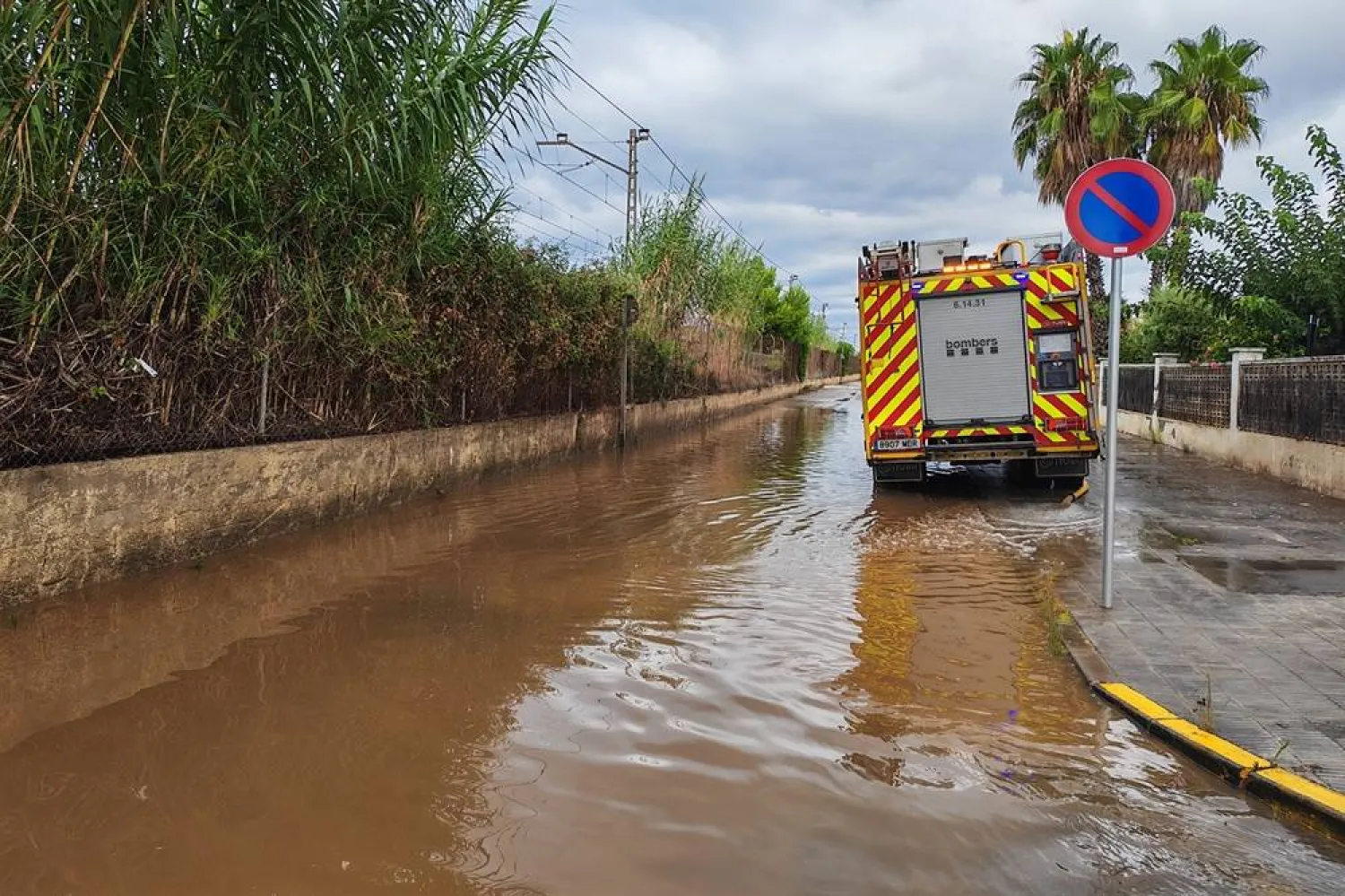 A firefighting truck is seen along a flooded road after heavy rainfall in the town of Roda de Bera, Tarragona, Catalonia, northeastern Spain, 22 August 2026. (EPA) 