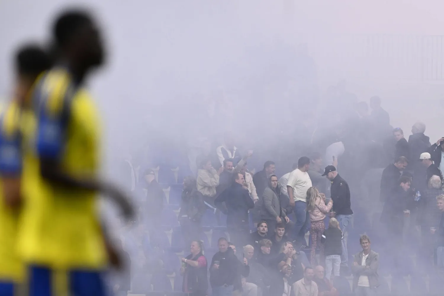 جماهير في المدرجات تشعل الألعاب النارية خلال مباراة كامبور وفينوورد في الدوري الهولندي لكرة القدم (إ.ب.أ)