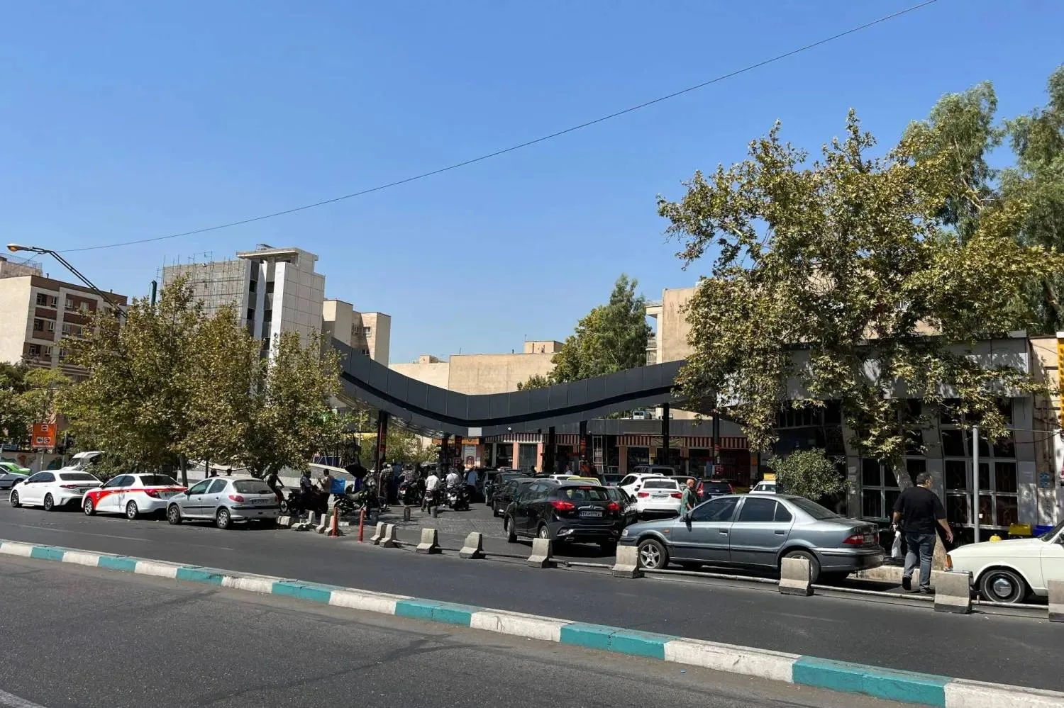 Drivers queue at a petrol station to refuel in Tehran, on August 25, 2026. (AFP)
