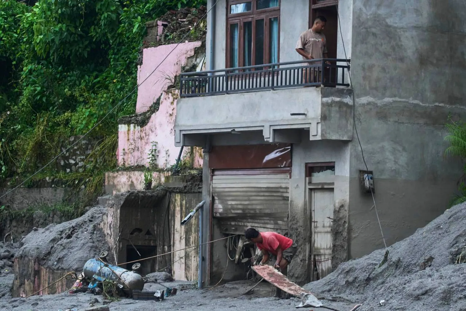 People amid damage in the aftermath of flash floods in Devighat in the Nuwakot district in Nepal, Thursday, Aug 27, 2026. (AP Photo/Niranjan Shrestha)