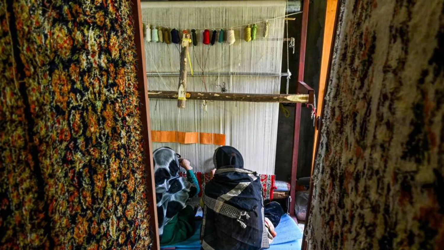 (FILES) Kashmiri craftswomen weave silk carpets at a factory in Srinagar on May 6, 2026. Tauseef MUSTAFA / AFP
