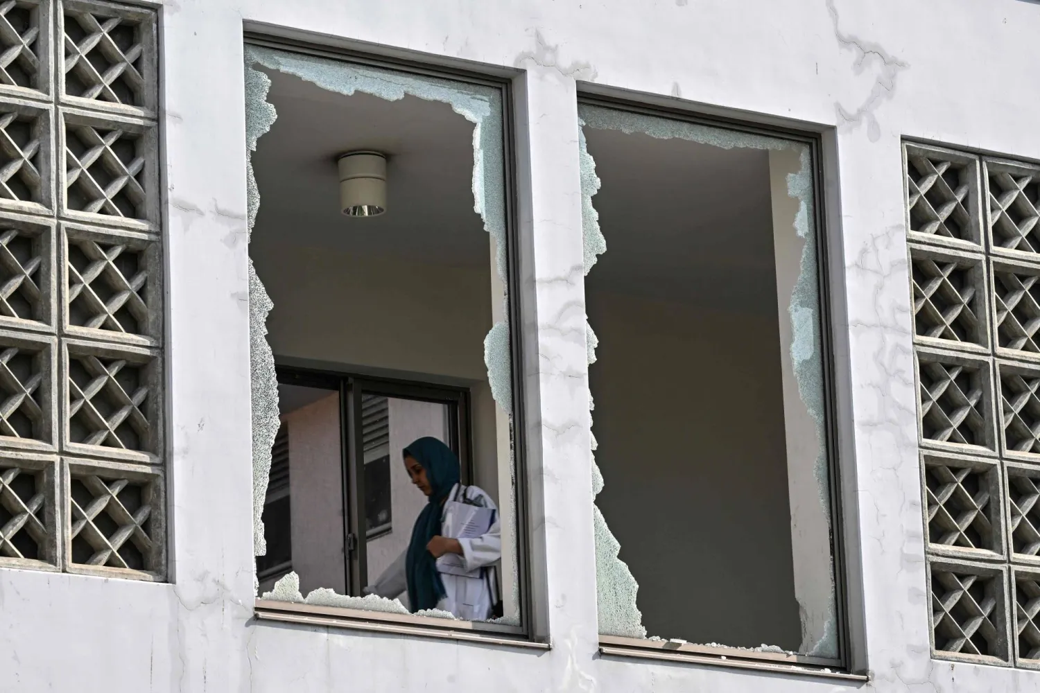 A medical staff member walks past a damaged corridor at the site, a day after a fire at the Mother and Child Health ward of the Pakistan Institute of Medical Sciences (PIMS) Hospital in Islamabad on August 27, 2026. (AFP)