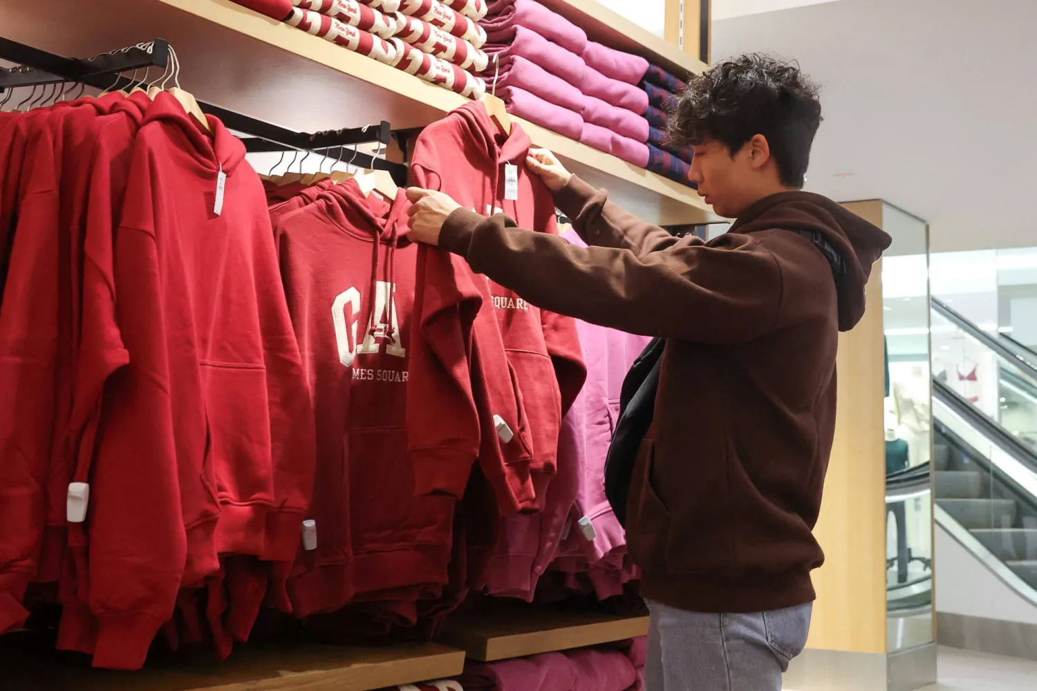 A person shops at a Gap store in Times Square in New York City, US, November 28, 2024. (Reuters)
