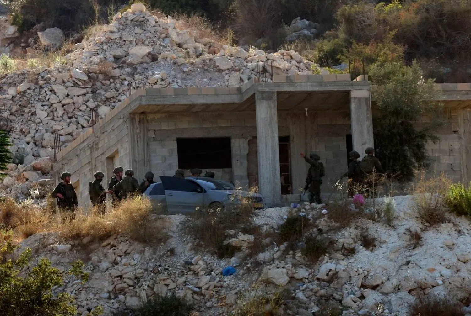Israeli troops search the area following an airstrike that killed three Palestinians near the West Bank city of Jenin, 28 August 2026. (EPA)