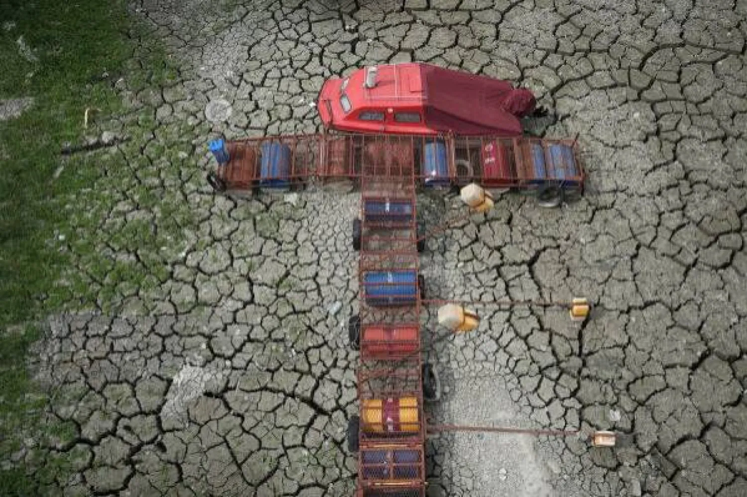 A boat sits on dry ground as water levels have dropped on the Danube in Petrovaradin, Serbia, Tuesday, August 25, 2026. (AP Photo/ Darko Vojinovic)