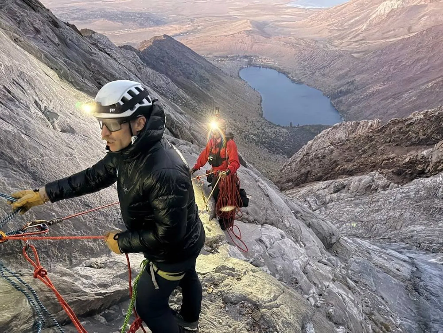 This photo released by the Mono County Search and Rescue shows volunteers conducting an operation to rescue a man stranded on a ledge in the Sierra Nevada, Calif., on Aug. 22, 2026. (Mono County Sheriff Search and Rescue via AP) 