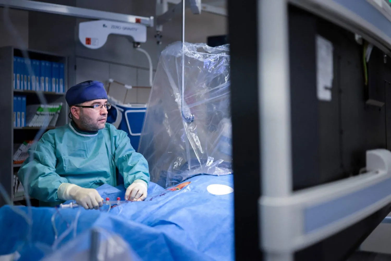 Cardiologist Ayman Alyoussef, who came to Germany from Syria in 2014, is treating a patient in the operating room of the cardiac catheterization lab at Harzklinikum Dorothea Christian Erxleben, in Quedlinburg, eastern Germany, on August 27, 2026. (AFP)
