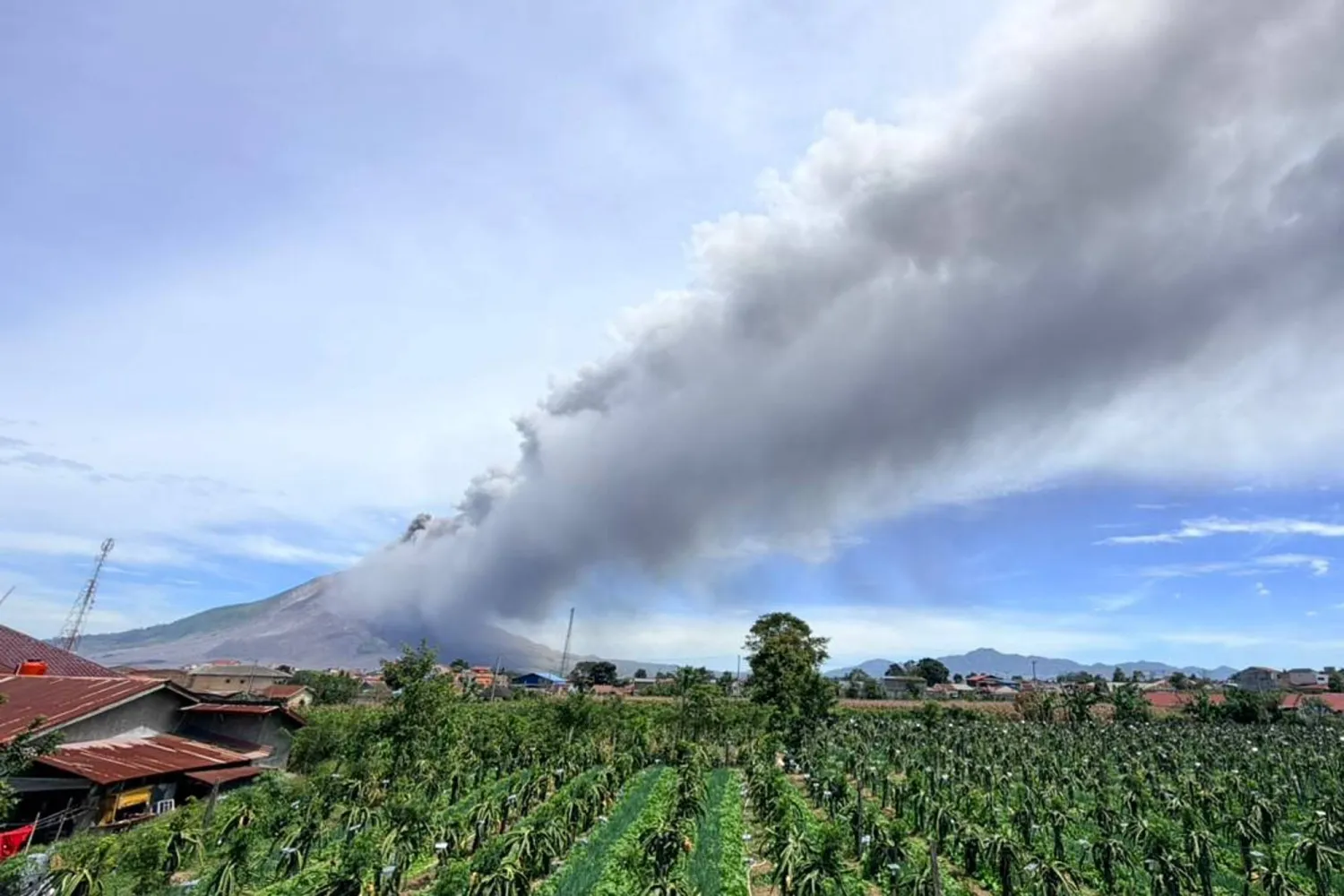 In this photo released by the Geological Agency (Badan Geologi) of Indonesia's Ministry of Energy and Mineral Resources, Mount Sinabung releases volcanic materials into the air during an eruption in Karo, North Sumatra, Indonesia, Monday, Aug. 31, 2026. (Badan Geologi via AP) 