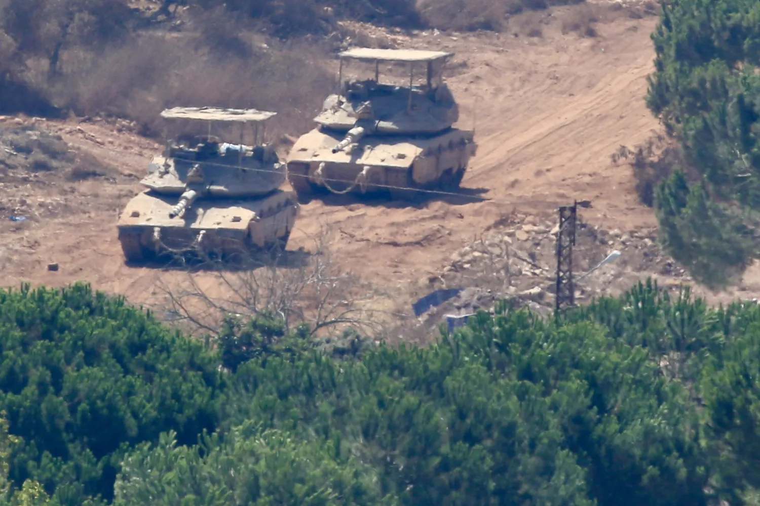 Israeli tanks in Zawtar al-Sharqiyeh as seen from Zawtar al-Gharbiyeh, southern Lebanon, 05 August 2026. (EPA) 