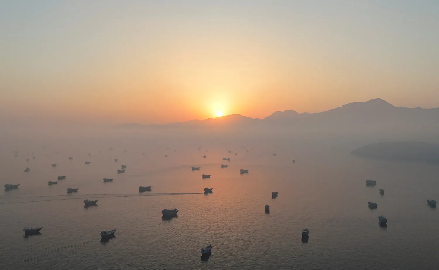 A drone view shows vessels in the Strait of Hormuz, as seen from Musandam, Oman, June 15, 2026. (Reuters)