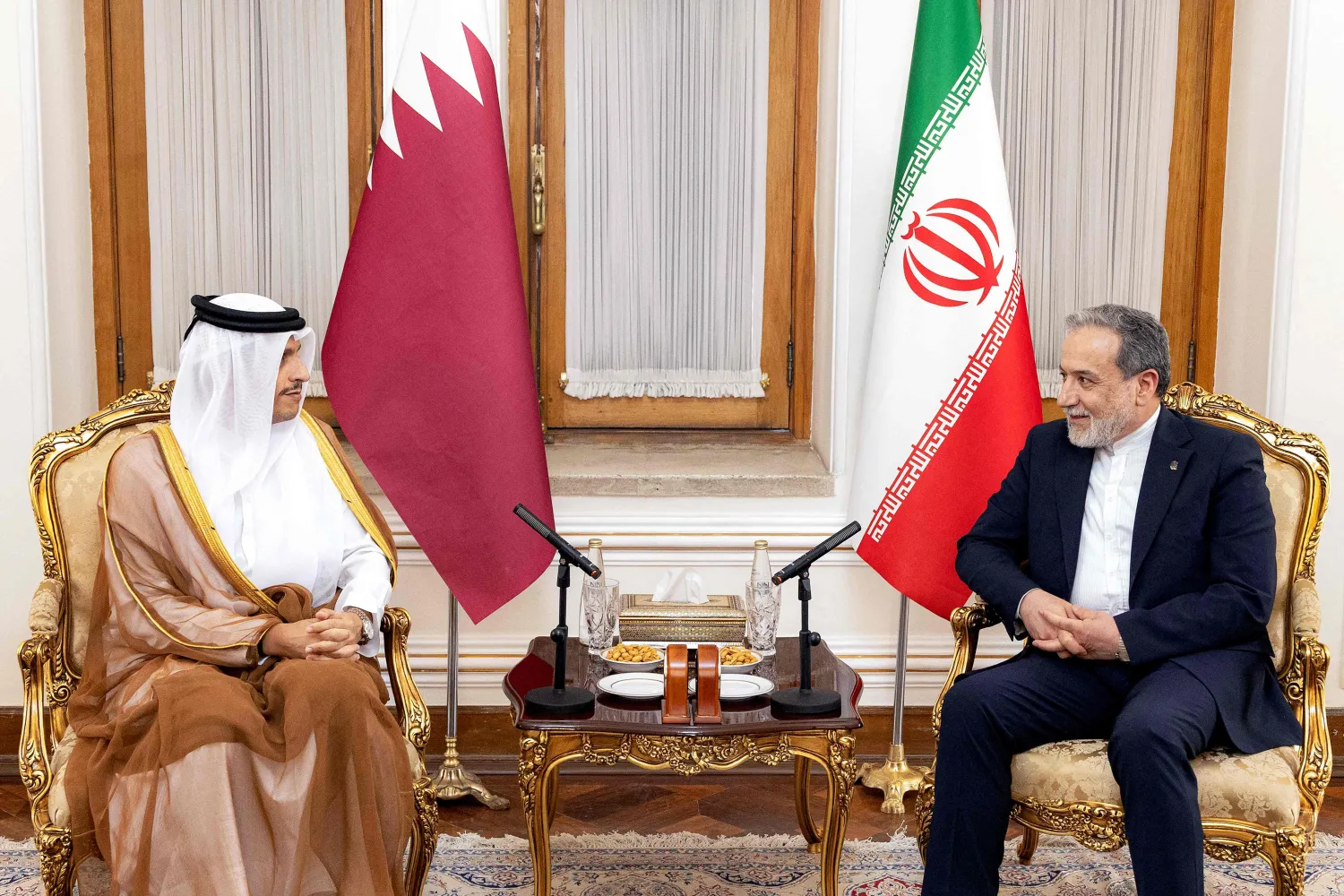 This handout picture released by the Qatari Ministry of Foreign Affairs shows Qatar's Prime Minister and Foreign Minister Sheikh Mohammed bin Abdulrahman Al Thani, (L) meeting with Iran's Foreign Minister Abbas Araghchi (R) in Tehran on August 27, 2026. (Qatari Ministry of Foreign Affairs / AFP) 