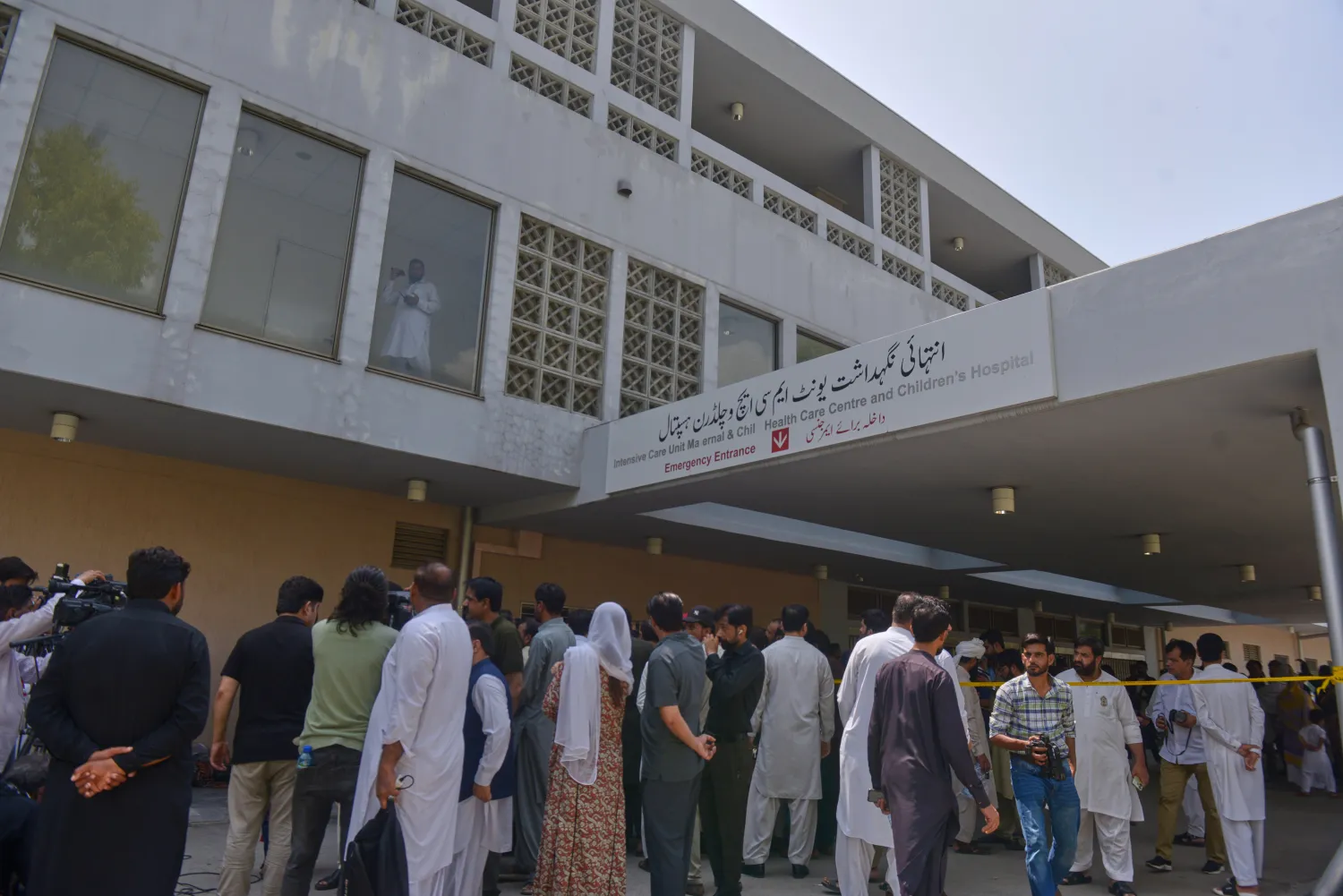 People gather outside a nursery in the gynecology ward following a fire at a hospital in Islamabad, Pakistan, Wednesday, Aug. 26, 2026. (AP)