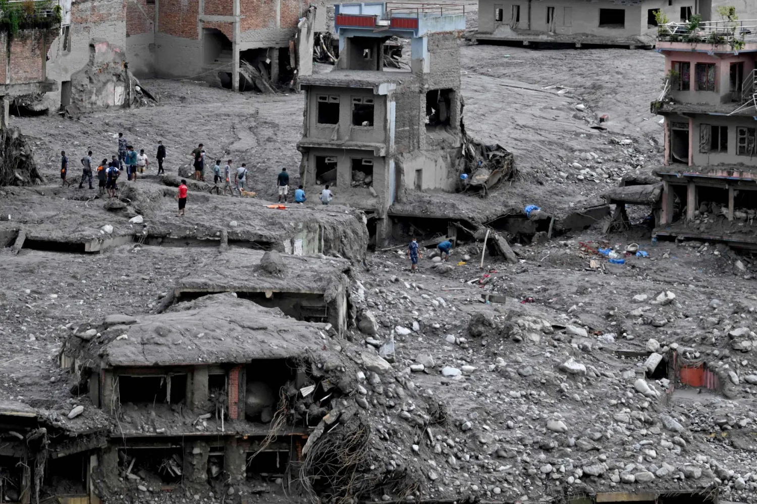 People scout for usable materials from debris after flash floods at Trishuli Center in Nepal's Nuwakot district on September 1, 2026. (AFP)