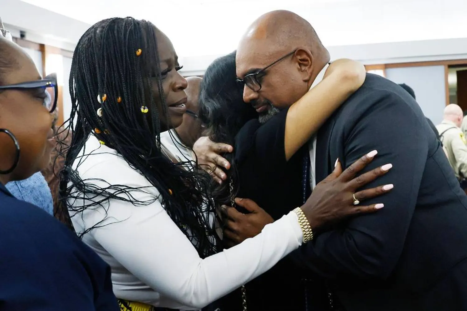  Friends and family members of rapper Tupac Shakur, including his sister Sekyiwa Shakur, second left, line up to hug Chief Deputy District Attorney Binu Palal, right, after a jury found Duane Davis guilty of first-degree murder in his trial related to the 1996 killing of rapper Tupac Shakur, at Clark County District Court Regional Justice Center, Monday, Aug. 31, 2026, in Las Vegas. (Bizuayehu Tesfaye/Las Vegas Review-Journal via AP, Pool) 