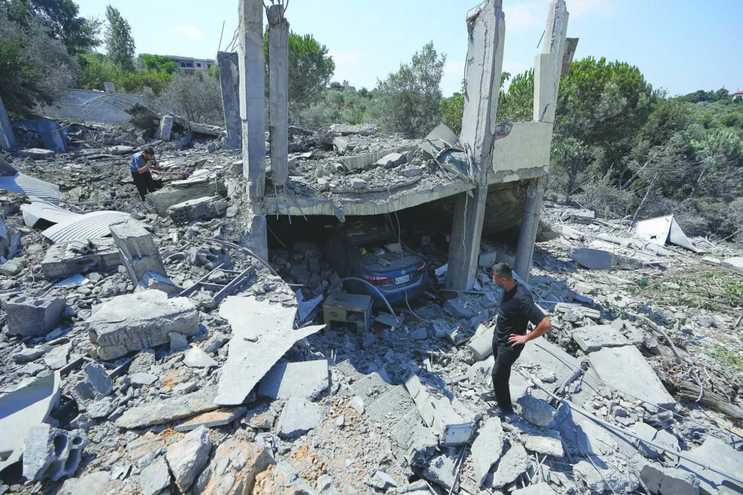  People check debris of a destroyed house that was hit on Thursday in an Israeli airstrike in Arab Salim village, southern Lebanon, Friday, Aug. 28, 2026. (AP) 