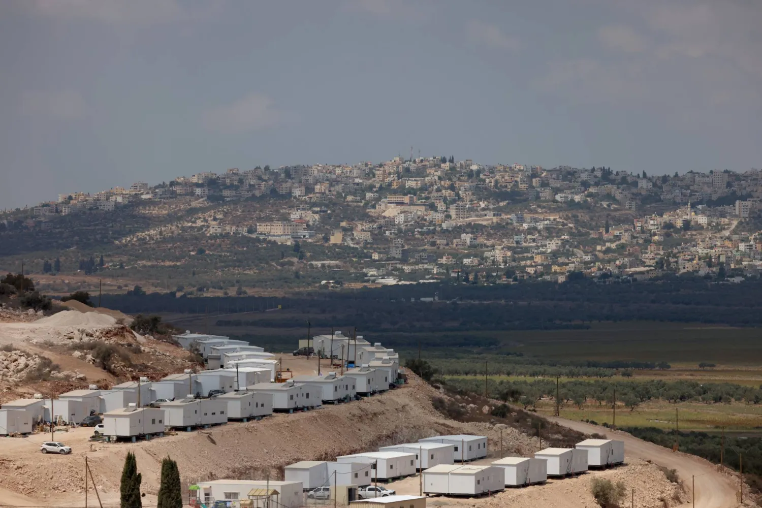 The new Israeli settlement “Dotan Valley”, as seen from Arraba whilst Israeli bulldozers uproots olive trees from Palestinian farms in Araba village near the west bank city of Jenin, 01 September 2026. (EPA) 