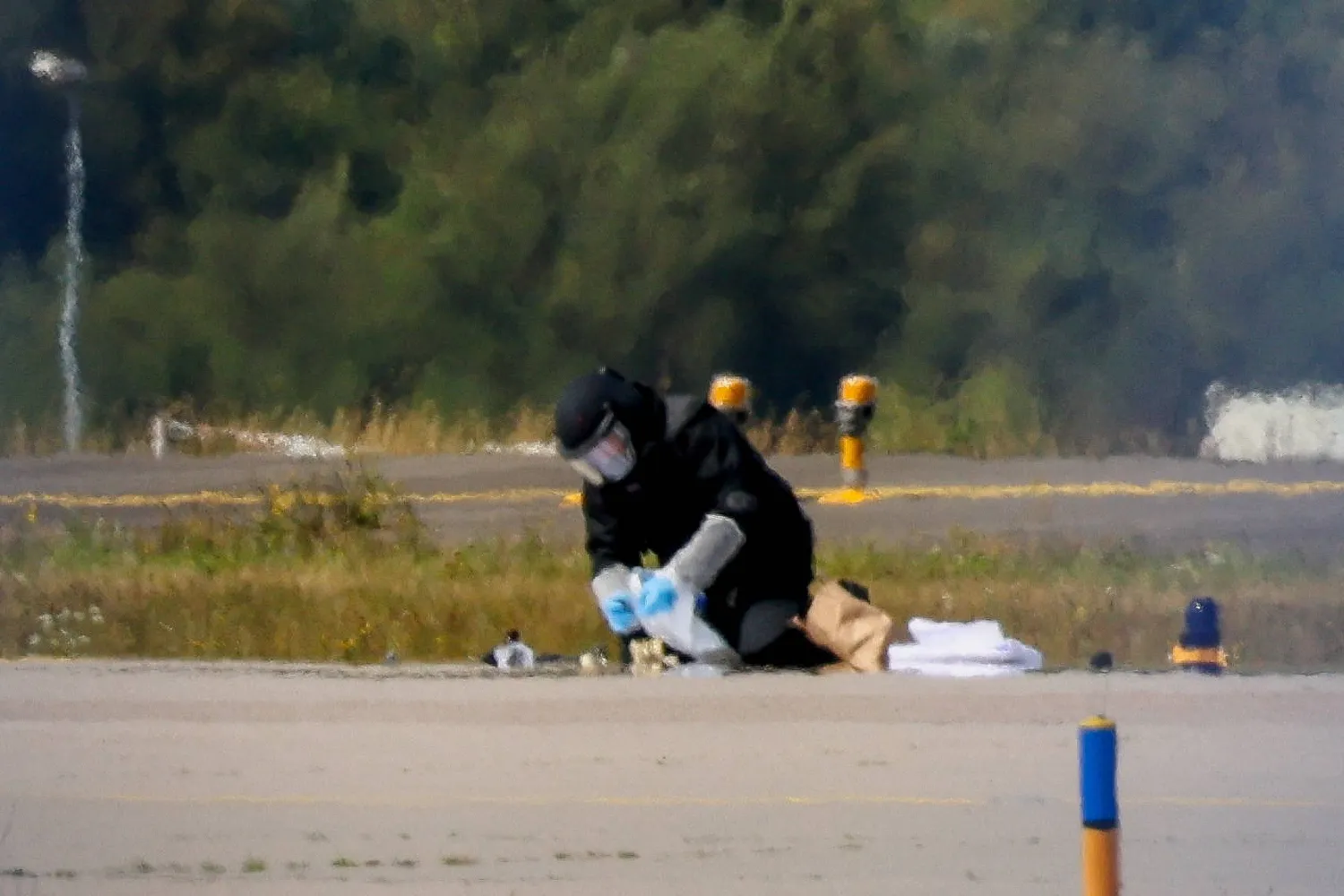 A police officer in protective clothing works at Leipzig/Halle Airport in Schkeuditz, Germany, August 5, 2026, after the police said explosives experts examined a drone near a runway. (Reuters) 
