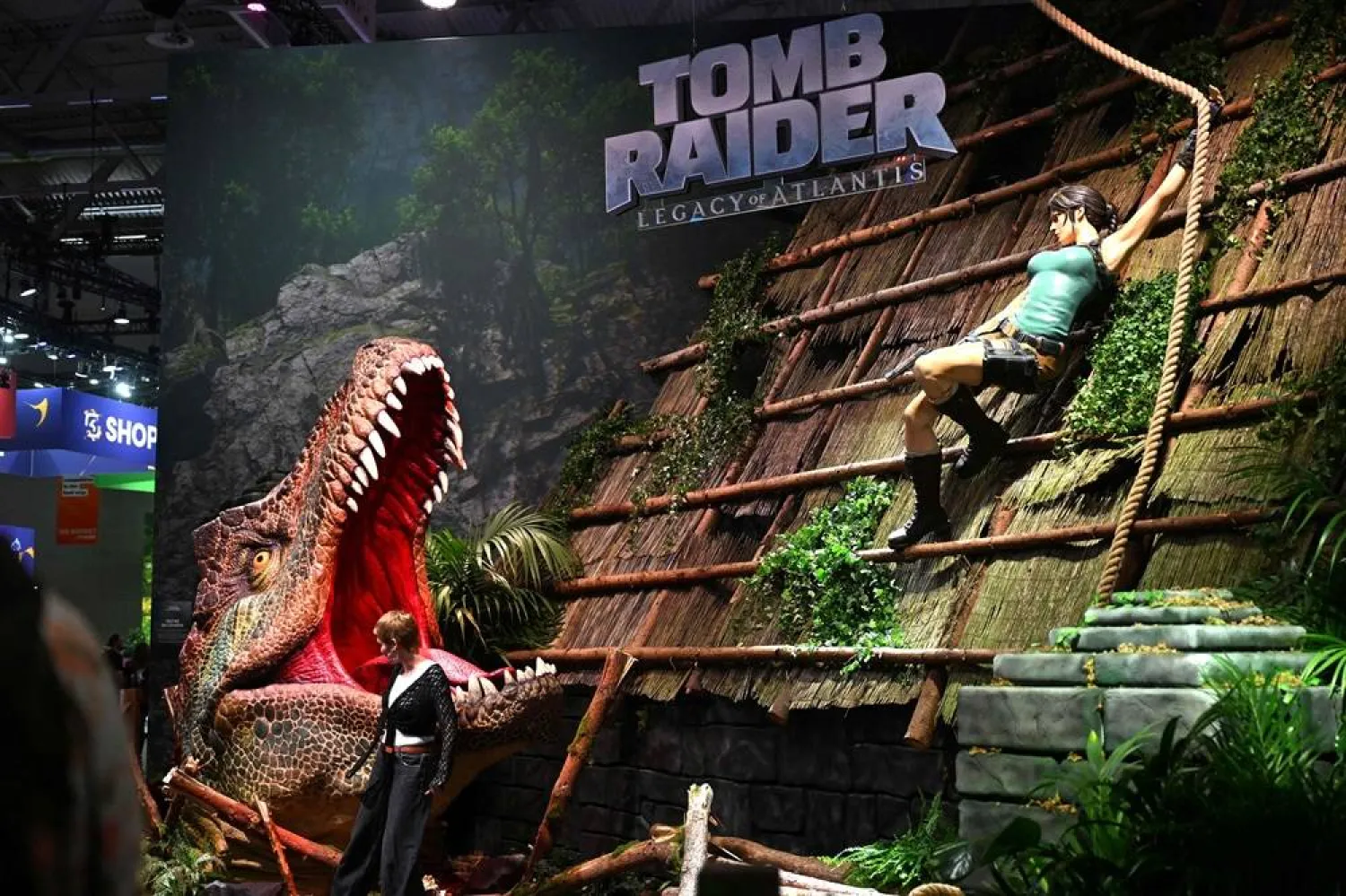 A visitor poses at the "Tomb Raider: Legacy of Atlantis" video game of Crystal Dynamics and Flying Wild Hog during at the Gamescom video games trade fair on the fair grounds in Cologne, western Germany, on August 26, 2026. (AFP)