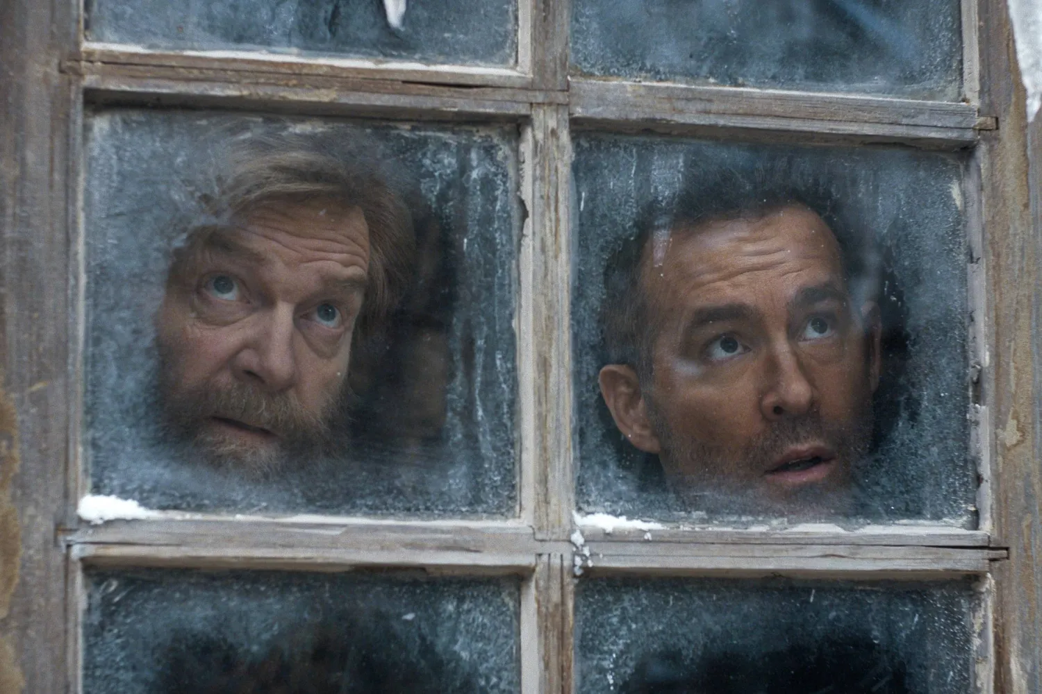 This image released by Apple TV shows Kenneth Branagh, left, and Ryan Reynolds in a scene from "Mayday." (Apple TV via AP) 