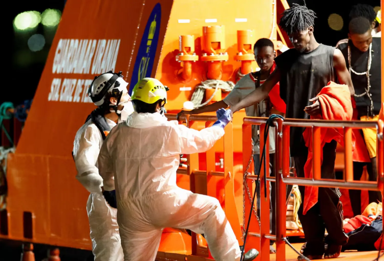 Rescuers help a migrant disembarking from a Spanish coast guard vessel at the port of Arguineguin, on the island of Gran Canaria, Spain, September 3, 2026. REUTERS/Borja Suarez 