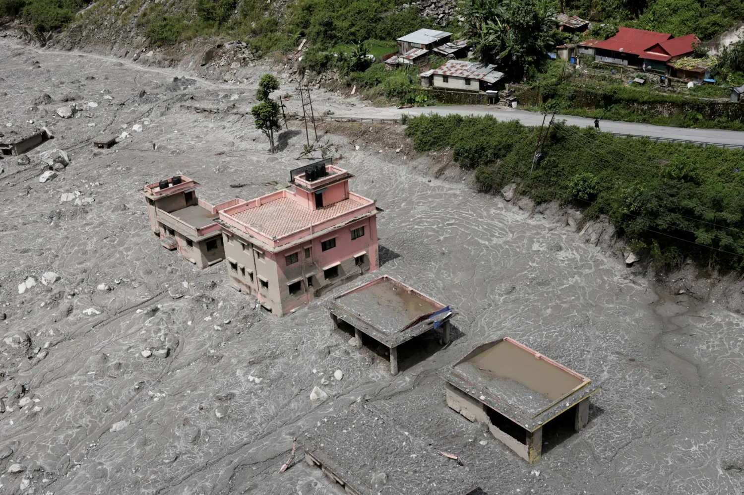 An aerial view shows houses standing amid debris during a helicopter flight from Nuwakot to Rasuwa following the deadly flash floods and mudslides in Nepal, September 3, 2026. (Reuters)