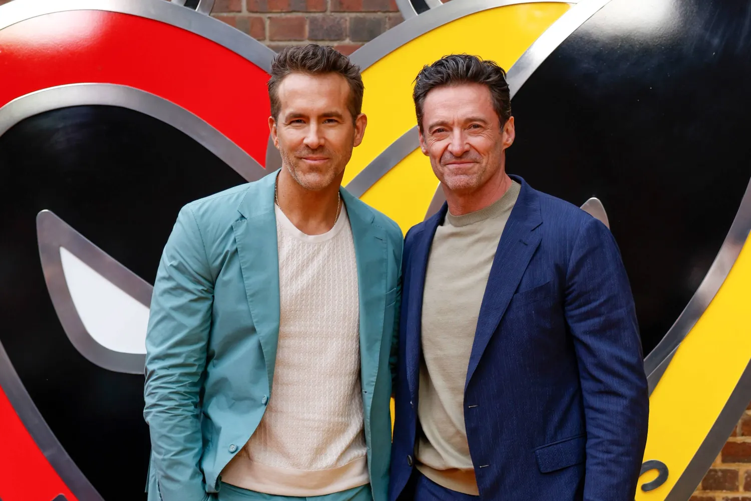 Ryan Reynolds, left, and Hugh Jackman pose for photographers upon arrival at the screening of the film "Deadpool & Wolverine" on July 11, 2024 in London. (AP)