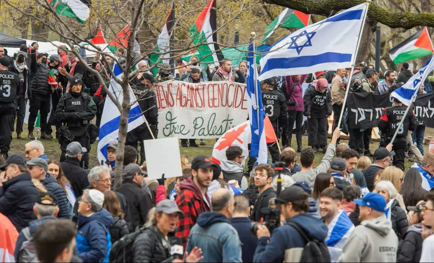 Police stand between counter-protesters and a protest encampment in support of Palestinians, during the conflict between Israel and the Palestinian group Hamas, at McGill University’s campus in Montreal, Quebec, Canada May 2, 2024. (Reuters) 