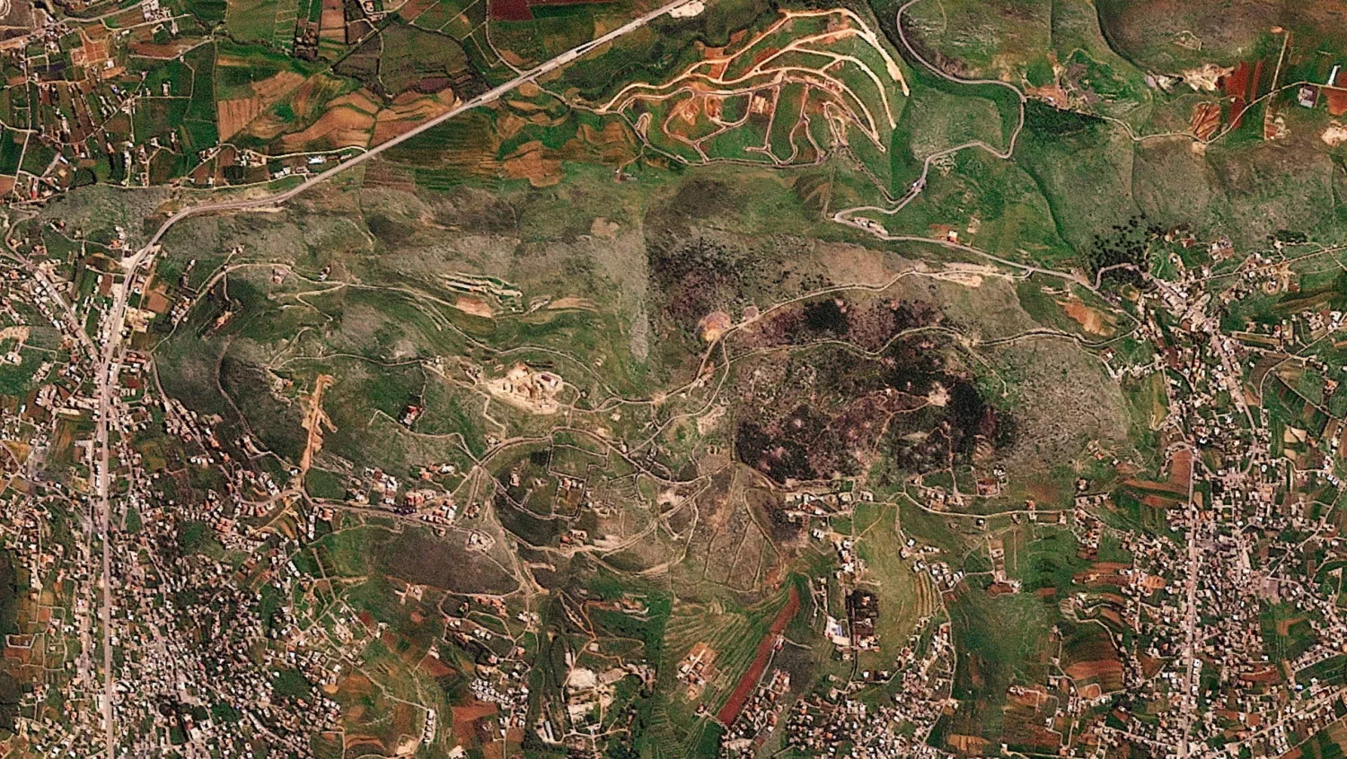 A satellite image shows damage at the Ali al-Taher ridge near Nabatiah, Lebanon, March 8, 2026. 2026 (Planet Labs PBC/Handout via Reuters)