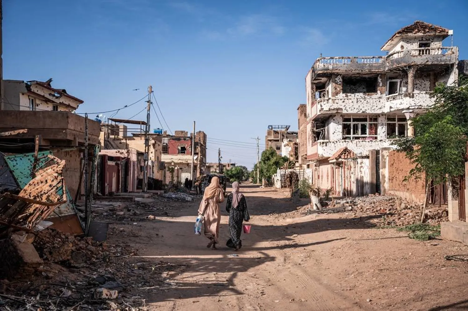  Women walk through a war-torn neighborhood in Sudan's Omdurman on November 2, 2024. (AFP)