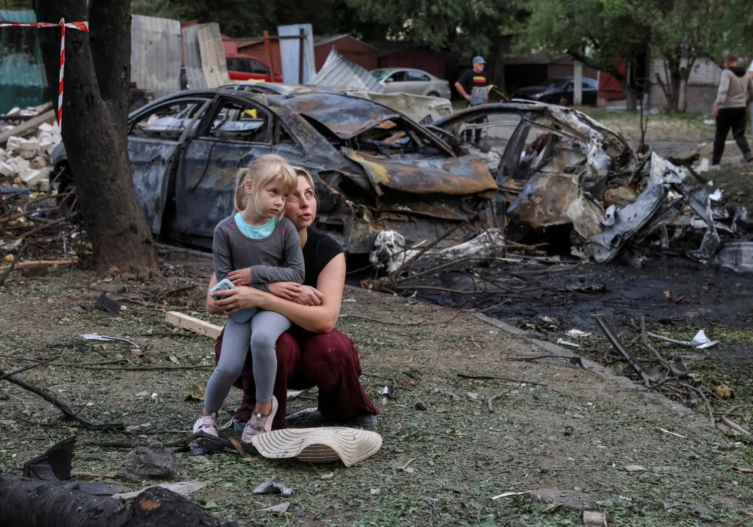 A resident Nataliia and her daughter Elia, 6, sit at a site of an apartment building damaged by a Russian missile strike, amid Russia's attack on Ukraine, in the town of Borispil, Ukraine September 1, 2026. REUTERS/Stringer  