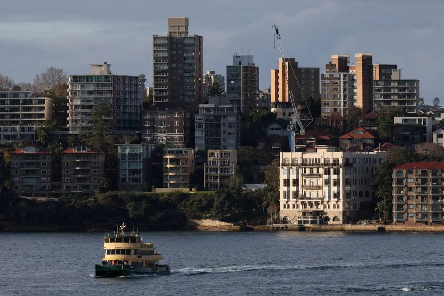 A ferry passes in front of apartments in Sydney, Australia, August 18, 2026. (Reuters)