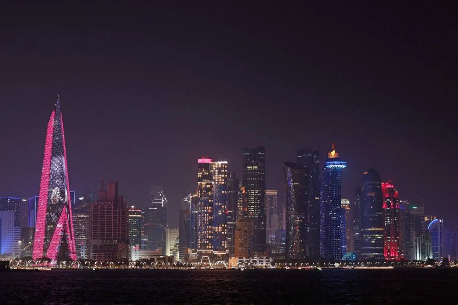The skyline of illuminated high-rise buildings is seen along the Corniche Promenade in Doha on September 4, 2026. (AFP)