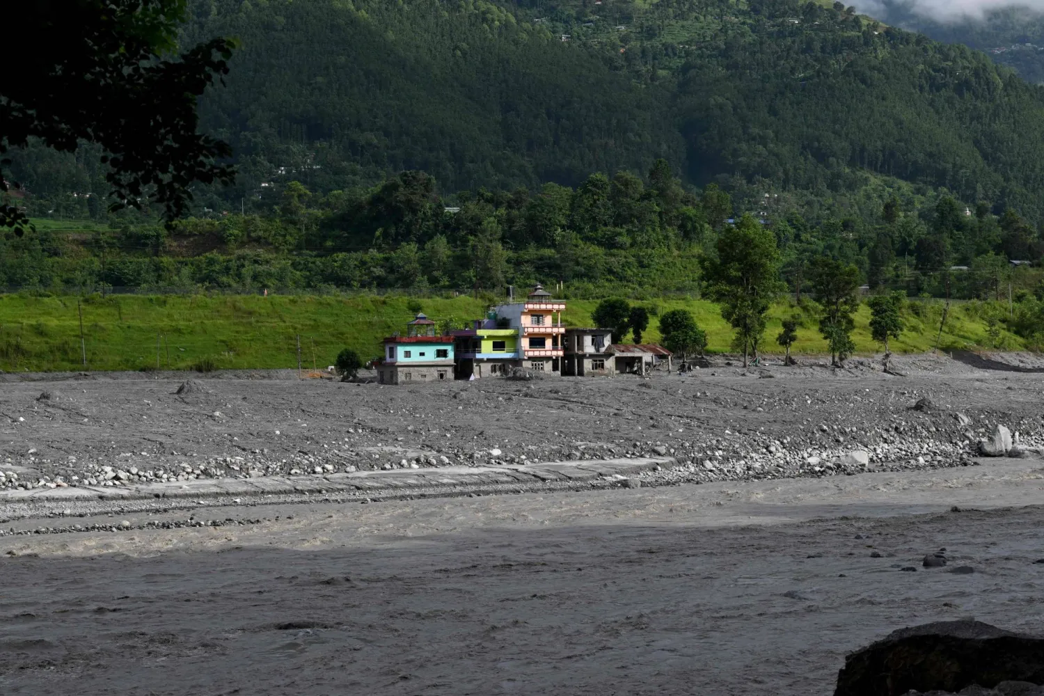 Damaged and sludge-ridden houses line the Trishuli riverbank in the aftermath of flash floods at Trishuli Bazar in Nepal's Nuwakot district on September 5, 2026. (AFP)