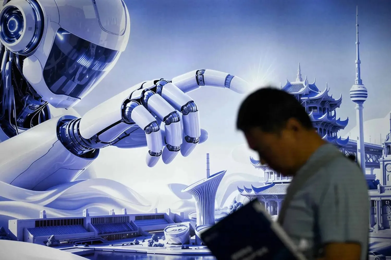 A man stands next to a poster of a humanoid robot during the China International Supply Chain Expo (CISCE) in Beijing on June 25, 2026. (AFP)