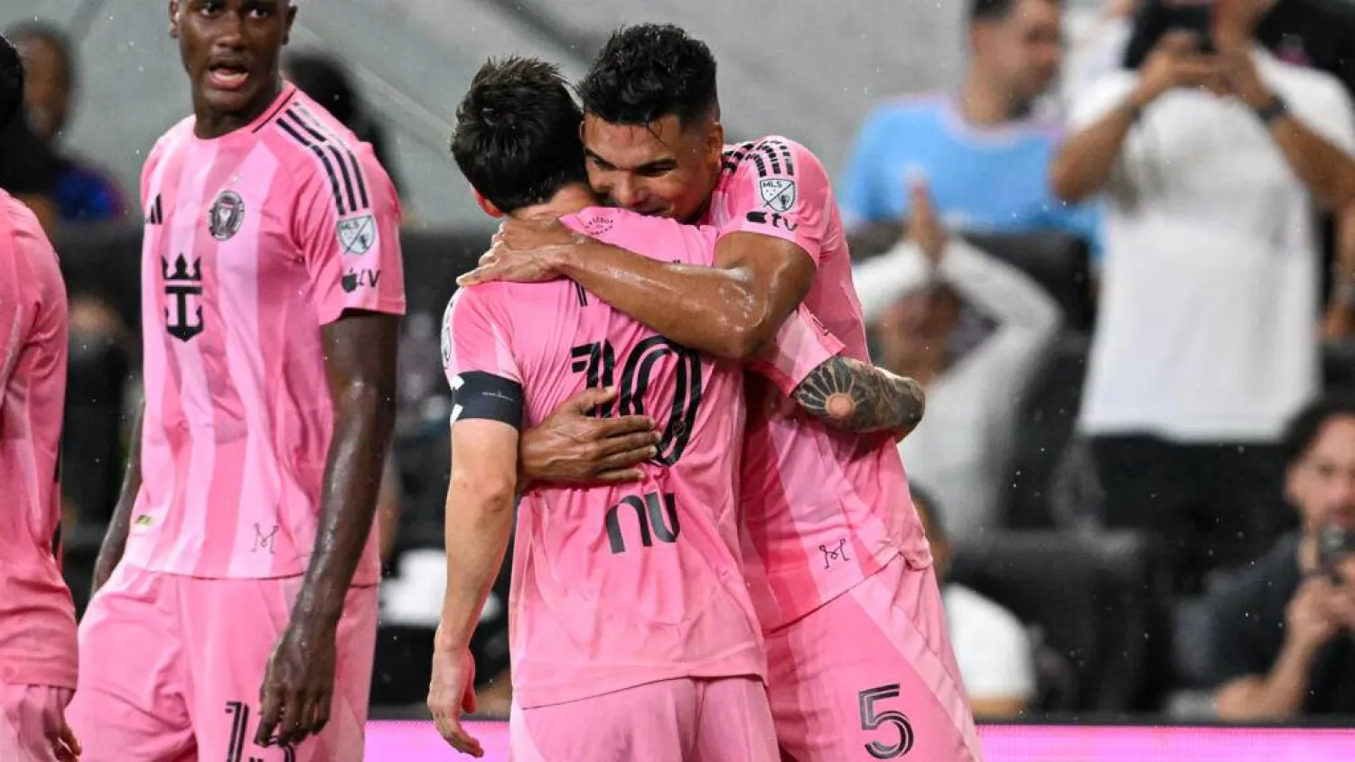 Inter Miami's Argentine forward Lionel Messi, center, is hugged by teammate Casemiro, right, scored a goal off a Messi corner kick in a 2-2 MLS draw with Atlanta. CHANDAN KHANNA / AFP
