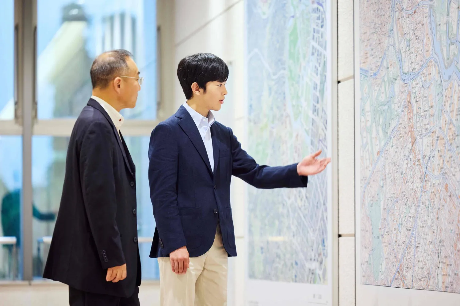 In this handout photo taken by the Imperial Household Agency of Japan on August 13, 2026 and released on September 6, 2026, Japan's Prince Hisahito (R) visits the Science Museum of Map and Survey in Tsukuba, Ibaraki Prefecture, northeast of Tokyo, ahead of his 20th birthday. (Photo by Handout / Imperial Household Agency of Japan / AFP)