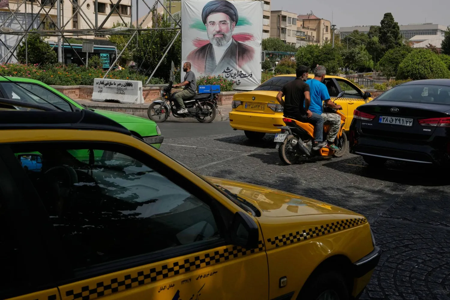  Vehicles pass a banner showing a portrait of the Iranian Supreme Leader Mojtaba Khamenei, in downtown Tehran, Iran, Monday, Aug. 31, 2026. (AP) 