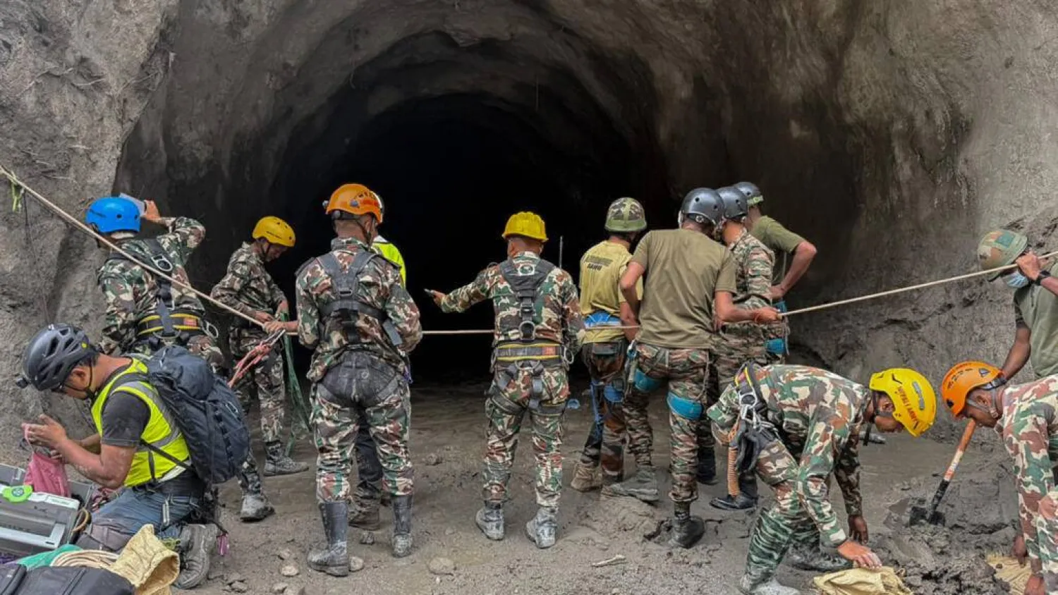 A handout photograph taken by the Nepal Army shows personnel conducting a search and rescue operation at the Rasuwagadhi Hydropower project in Rasuwa. Handout / NEPAL ARMY/AFP/File
