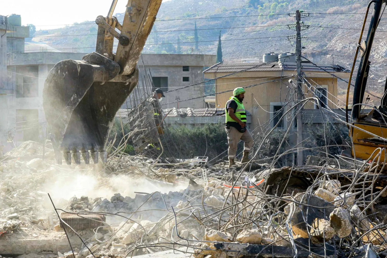 An excavator digs as rescuers search for survivors amidst the rubble following an overnight Israeli airstrike on the village of Kfar Rumman in southern Lebanon on September 7, 2026. (AFP)