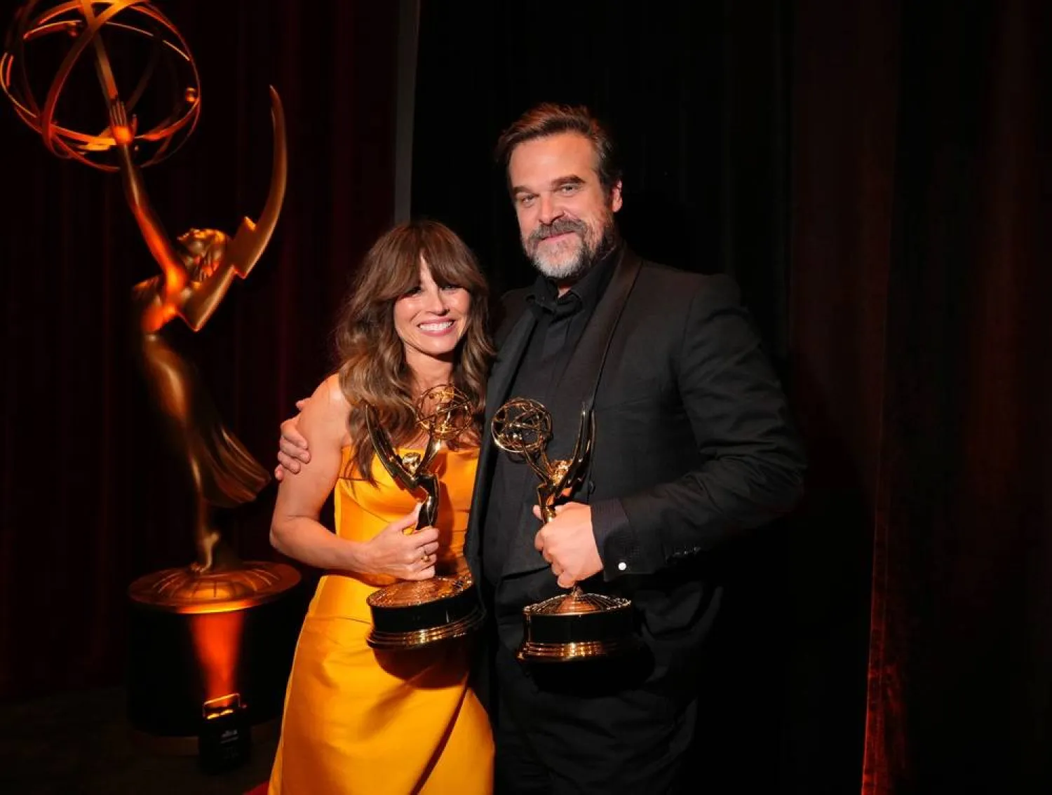Linda Cardellini, left, and David Harbour with their Emmys for Outstanding Supporting Actor in a Limited or Anthology Series or Movie for "DTF St. Louis" during night two of the Television Academy's 78th Emmy Awards at the Peacock Theater at L.A. LIVE on Sunday, Sept. 6, 2026 in Los Angeles. (Jordan Strauss/Invision for the Television Academy/AP) 