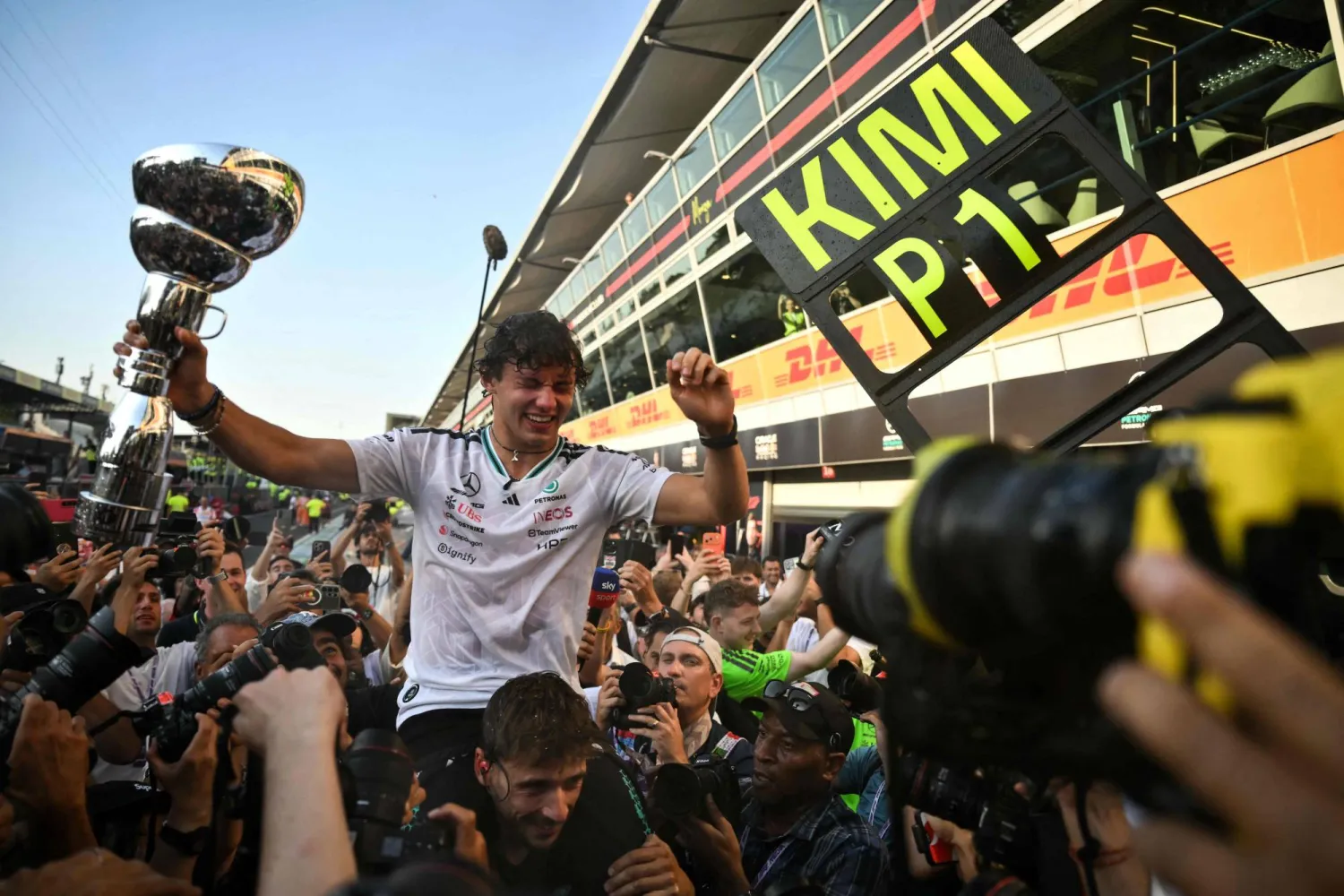 Mercedes' Italian driver Kimi Antonelli holds his trophy as he celebrates with his team members after winning the Italian Formula One Grand Prix at the Autodromo Nazionale Monza circuit in Monza, northern Italy on September 6, 2026. (AFP)