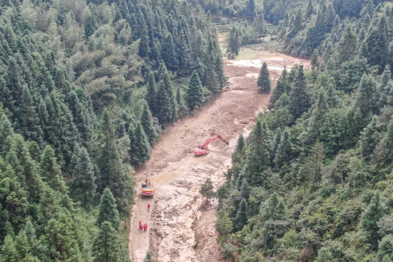 A drone view shows construction machinery clearing a road to the mudslide-hit Mingkeng village after heavy rainfall associated with Typhoon Saudel, in Suichuan county, Jian, Jiangxi province, China September 6, 2026. (cnsphoto via Reuters)