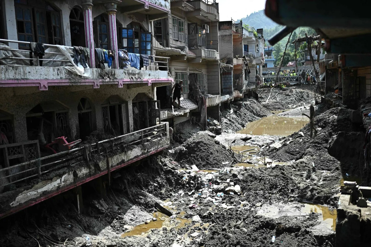 A man looks at the remains of sludge-ridden houses in the aftermath of flash floods at Devighat in Nepal's Nuwakot district on September 8, 2026. (AFP)