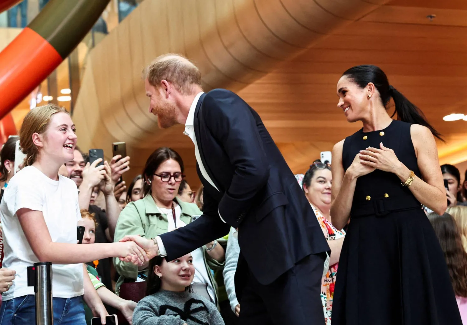 FILE PHOTO: Prince Harry, the Duke of Sussex, greets a girl as he visits the Royal Children's Hospital along with Meghan, Duchess of Sussex, in Melbourne, Australia, April 14, 2026. REUTERS/Mark Peterson/File Photo
