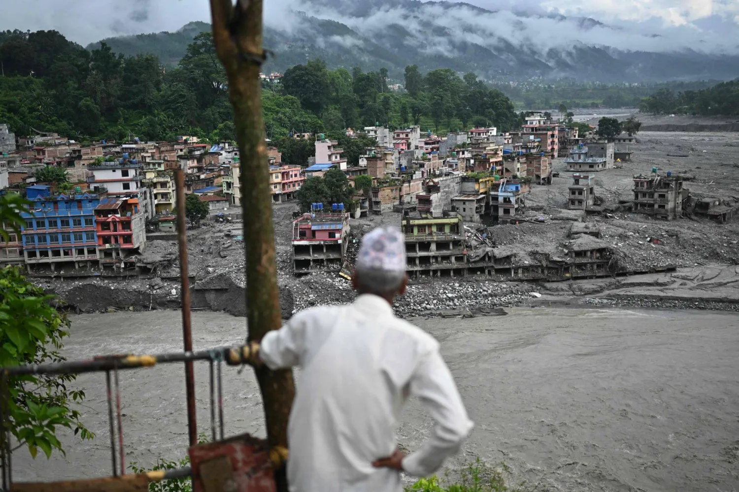 A man looks at the remains in the aftermath of flash floods at Trishuli in Nepal's Nuwakot district on September 7, 2026. (AFP)