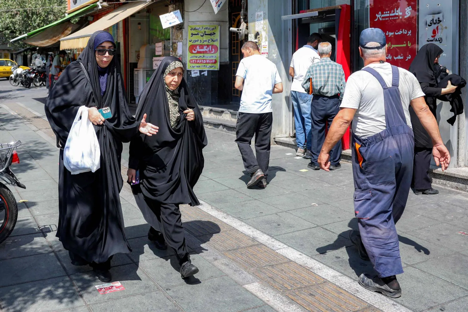 People walk along a market street in Tehran on September 7, 2026. (AFP)